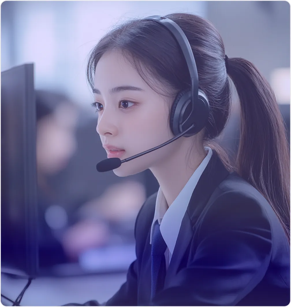 Young woman with a headset working at a computer in a professional setting.